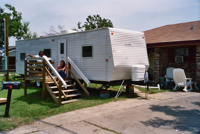 Photo of Regina and a neighbor on the front stoop of her FEMA trailer