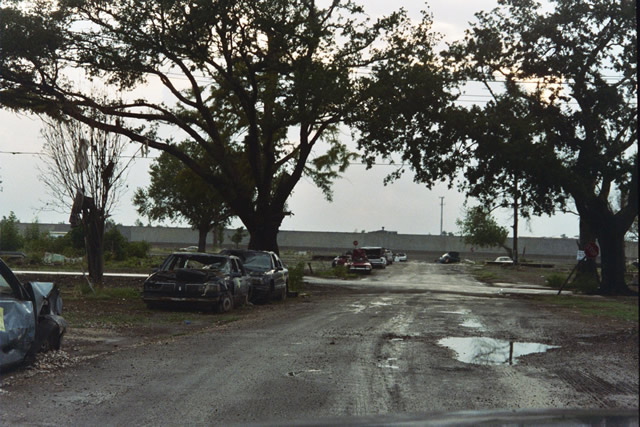 Photo of Lower Ninth Ward, a neighborhood scrapped clean of houses.  In the background is the canal dike that broke